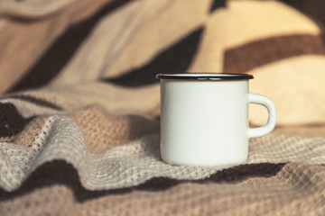 White campfire mug mockup with woven blanket