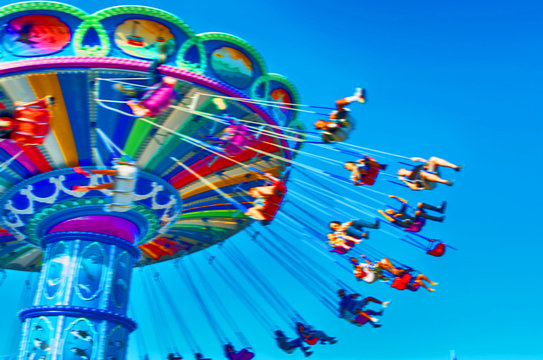 Blurred image of exciting carnival ride