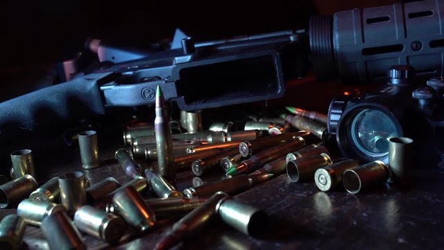 Gun Porn of ammo dropping in front of military riffle slow motion.