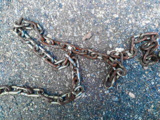 old rusty chain on the concrete floor