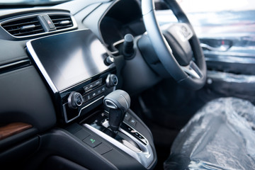 Fototapeta premium New cars in the luxury car interior showroom Steering wheel, gear lever and control panel