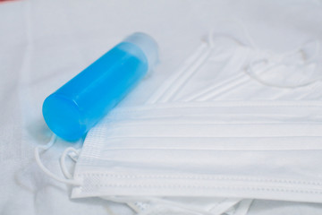 Health care and surgical concept. Coronavirus prevention medical surgical masks and hand sanitizes gel for hand hygiene corona virus protection.Cleaning product such as hygienic mask for disinfection.