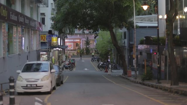 an empty street leading to low yat computer plaza