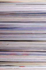 Closeup background of a pile of magazines.