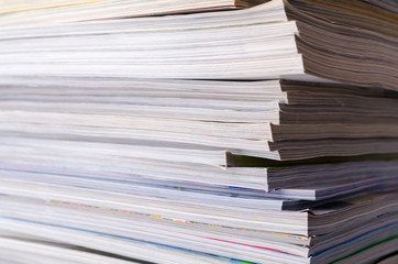 Closeup background of a pile of magazines.