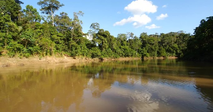 Speeding around a bend in  the Rio Tiputini, the Ecuadorian Amazon, the river runs through pristine primary rainforest bordering Yasuni National Park
