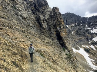 Hiking near the steep edge of a cliff while hiking the Crypt Lake Trail in Waterton Lakes National Park