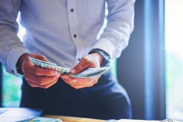 Businessman counting money dollar banknotes for business payment