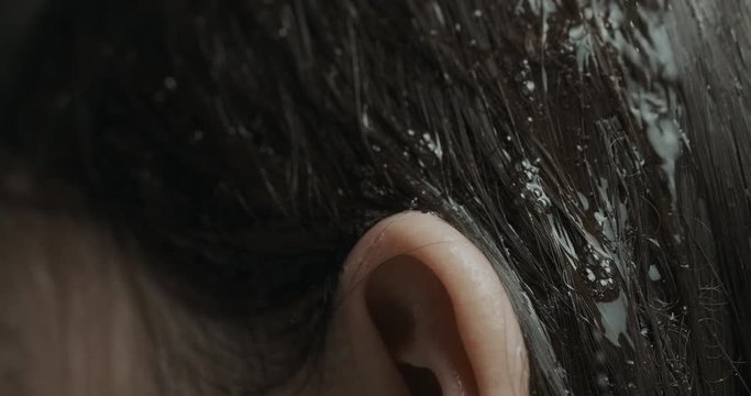 drops of water flow through the hair close up