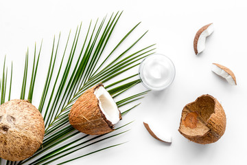 Skin care cream with coconut oil on white background top-down
