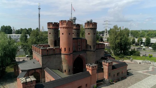 Kaliningrad fortress bastion type. Historical old building Friedrichsburg gate. Brick red towers. Culture heritage best main landmark. Russia East Prussia. Summer sunny. Aerial climb