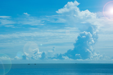 The white clouds with the blue sky and the beautiful blue sea give the feeling of stillness like paradise.