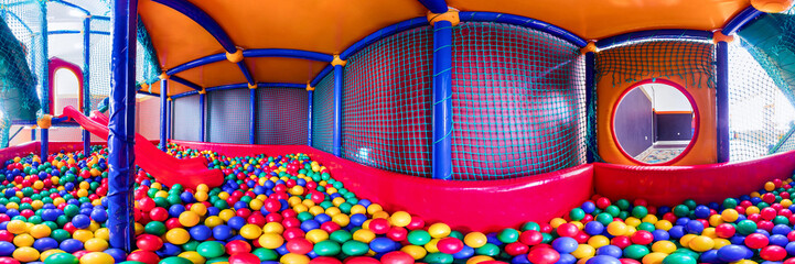 children's playroom with colorful balls and a slide made of plastic. . Cylindrical panorama 360