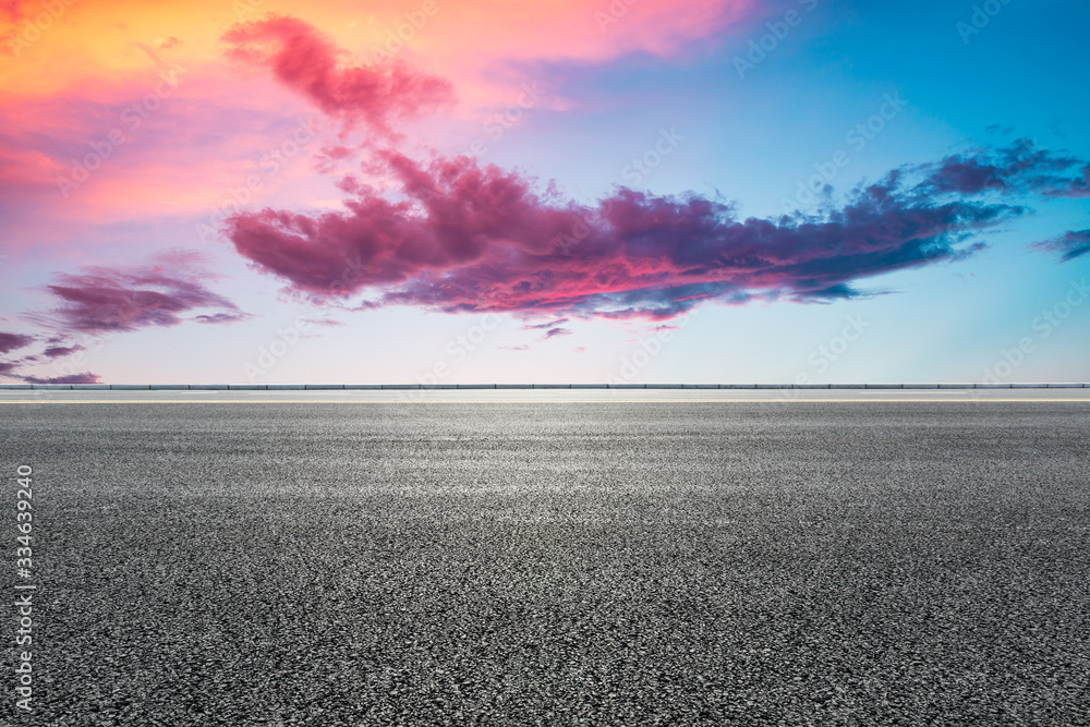 Wall mural Asphalt highway road and sky sunset clouds landscape.