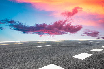 Asphalt highway road and sky sunset clouds landscape.