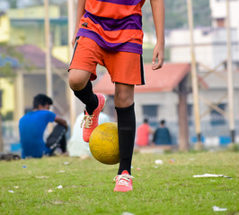 Soccer player in sports uniform juggling a football in sports field. Summer winter Olympics games Sports activities background Photography. - obrazy, fototapety, plakaty