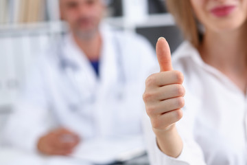 Arm show ok or confirm with thumb up at doctor office closeup. High level work confident satisfied...