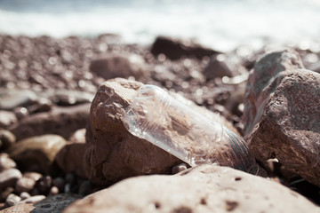 Trash, plastic, garbage, bottle ... environmental pollution on the beach, plastic bottle on the beach. Waste that pollutes the ocean environment