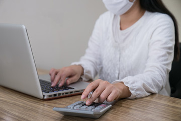 Closeup shot of woman using a laptop while working from home.