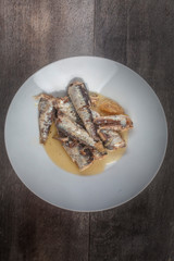 sardinas on plate on wood