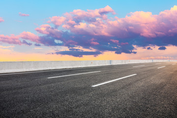 Fototapeta premium Asphalt highway road and sky sunset clouds landscape.