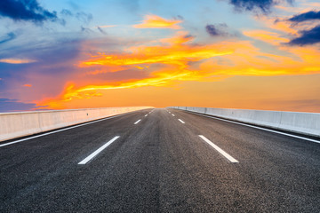 Obraz na płótnie Canvas Asphalt highway road and sky sunset clouds landscape.