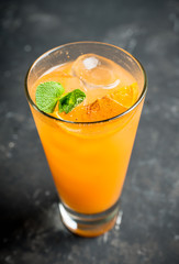 Fresh cocktail with vodka and orange juice on the rustic background. Selective focus. Shallow depth of field.