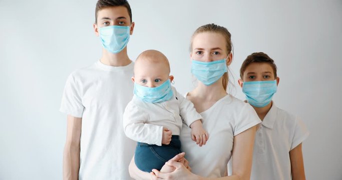 Family parents and children wear medical masks to prevent infection, airborne respiratory disease, coronavirus isolated on a white background