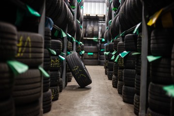 tires stacked stored in auto mechanics garage
