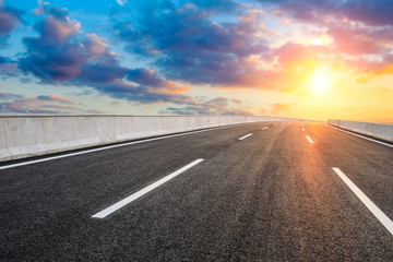 Asphalt highway road and sky sunset clouds landscape.