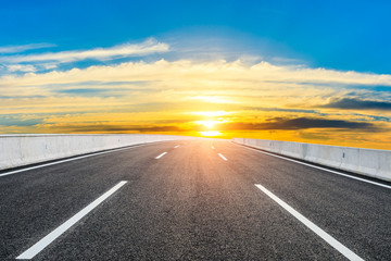 Asphalt highway road and sky sunset clouds landscape.