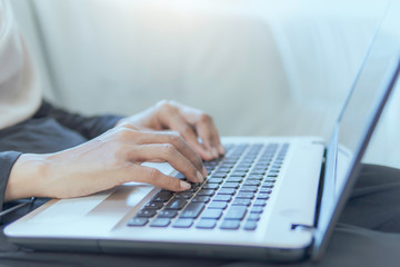 hands typing on laptop