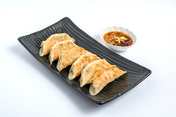 gyoza or dumplings snack with soy sauce on white isolated
