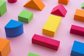 Obraz premium Set of colorful geometric cube or block toy on pink background. Abstract pattern design composition by shape and form. Education, business solution and creative design product concept.