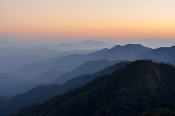 Layer of mountains and mist during sunset