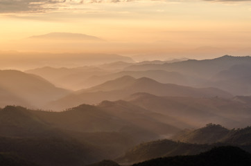 Layer of mountains and mist with ray of sunset