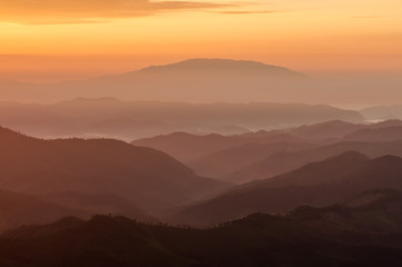 Fototapeta premium Layer of mountains and mist during sunset