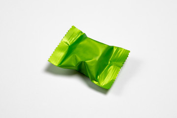 Blank packaging Candy plastic sachet isolated on white background.Candy wrapper Mock-up,Сan be used for design and branding.High resolution photo.