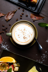 Hot cappuccino on a wooden table