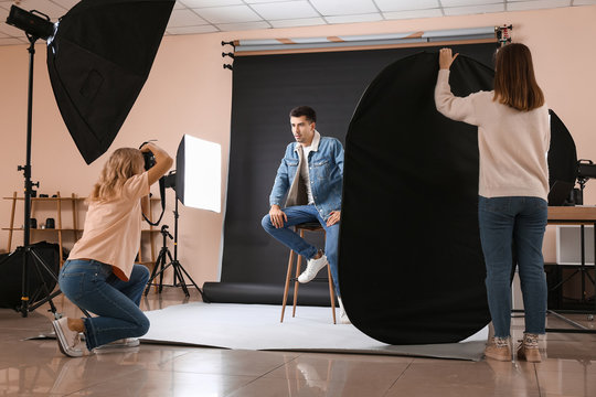 Professional photographer working with model in studio