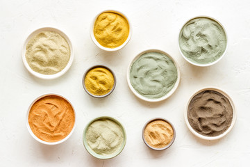 Blue, yellow, white. red, black cosmetic clay background on white table top-down pattern