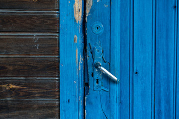 texture of a wooden door painted with blue paint