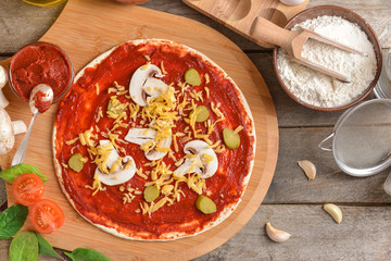 Preparing of tasty pizza on table