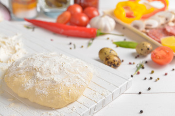 Dough for tasty pizza on table
