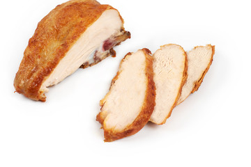 A close up of grilled, sliced chicken breast isolated on white background .