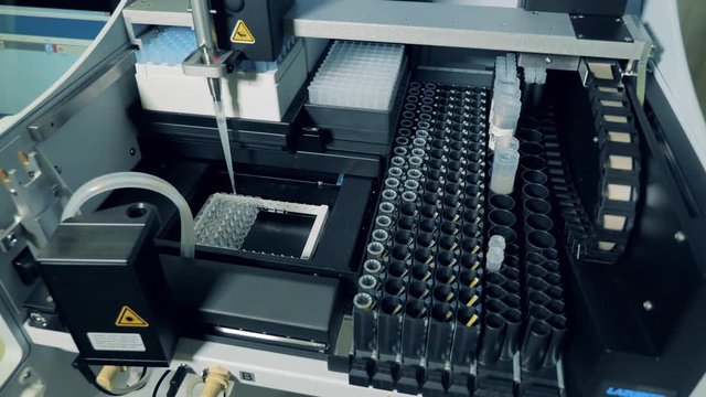Coronavirus 2019-nCoV detecting concept.Biochemical analyzer is filling in test tubes