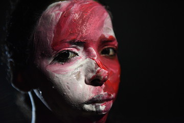 Beauty model girl with colorful paint on her face