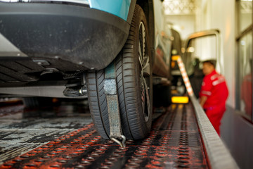 Tow truck towing a broken down car on the service center repair Loading broken car on a tow truck on a roadside