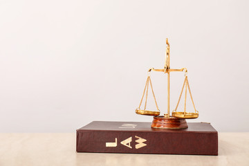 Scales of justice and book on table
