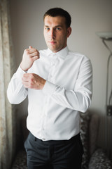 Beautiful man, groom posing and preparing for wedding